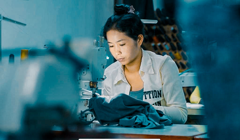 Eine Person von etwa drei Millionen aus Kambodscha, welche für die Herstellung von Kleidungsstücken zuständig ist.